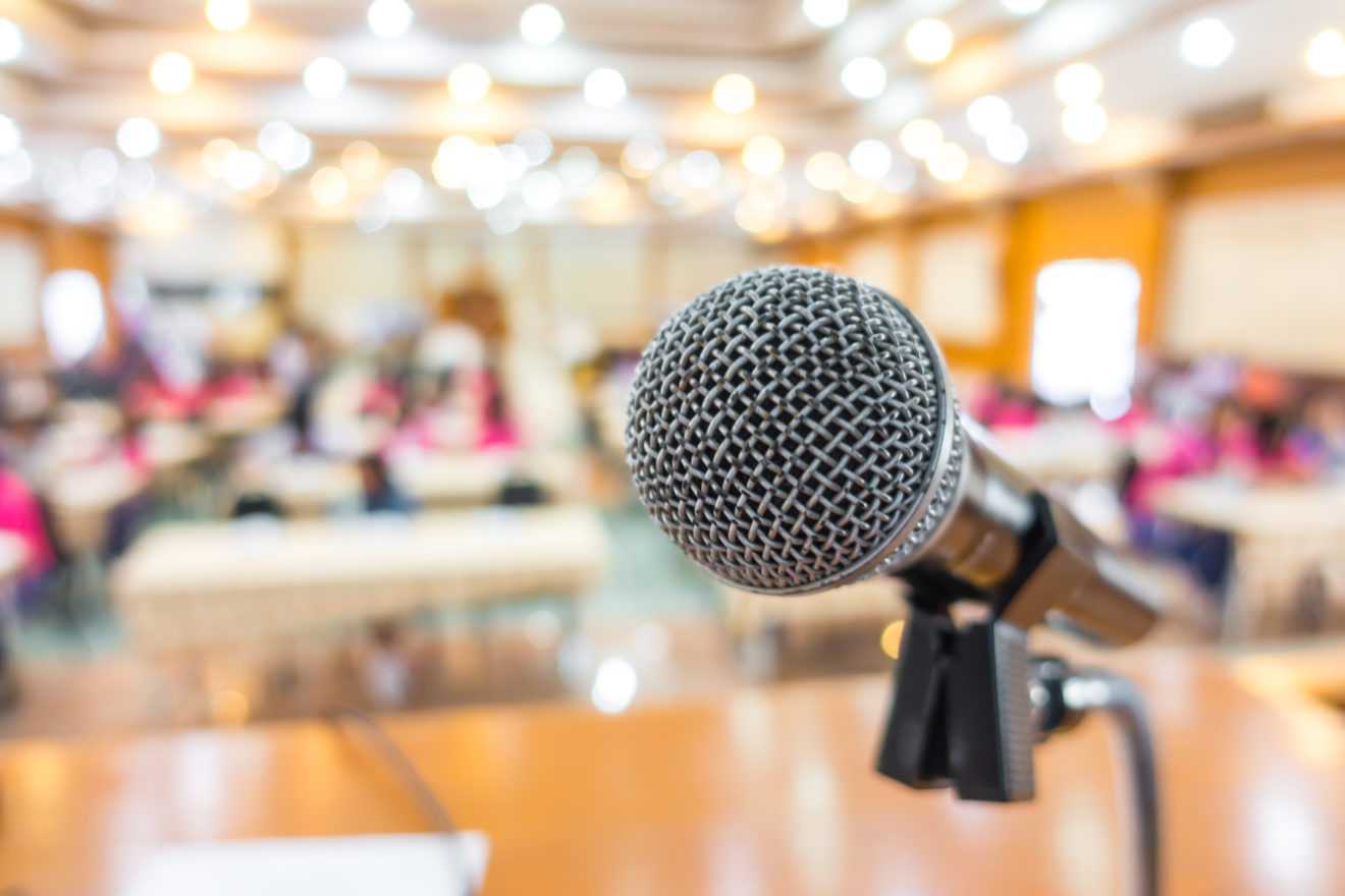 Black microphone in conference room .
